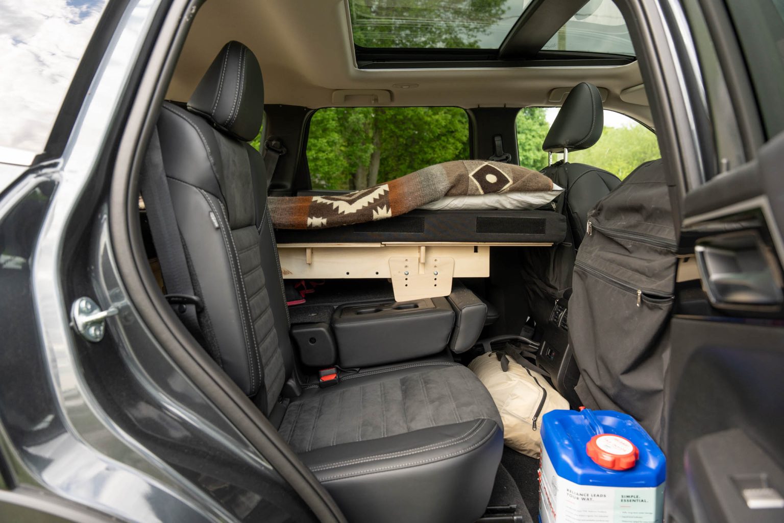 Roadloft camper kit designed to maintain access to passenger seats while allowing four-person travel.