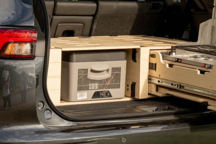 Dedicated space for a 15L to 30L fridge in the Roadloft SUV camper kit for efficient food storage.