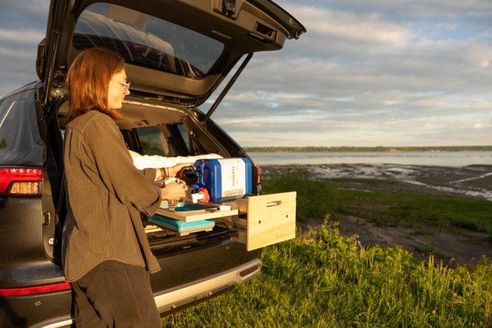 Retractable sink in the Roadloft SUV camper kit, designed for space-saving and convenience on the road.