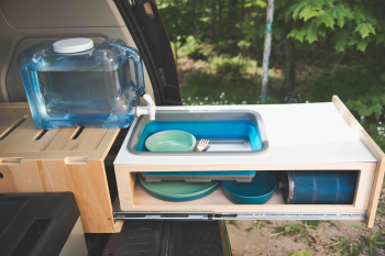 Retractable sink in the Roadloft minivan kit, designed for space-saving and convenient use while traveling.