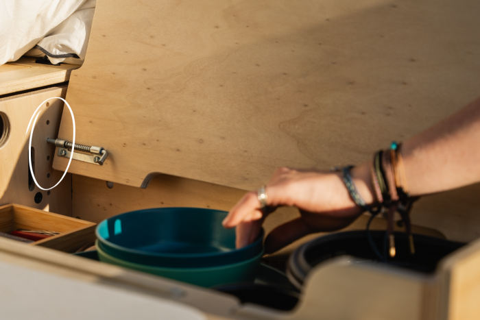 Adjustable-height shelf in the Roadloft camper conversion, designed for efficient and flexible storage.