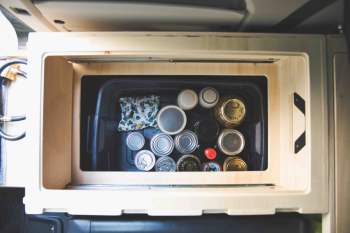 Additional storage under the drawers in the Roadloft minivan kit for extra organization.