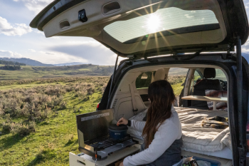 Ergonomic and accessible burner drawer in the Roadloft camper kitchen for convenient outdoor cooking.