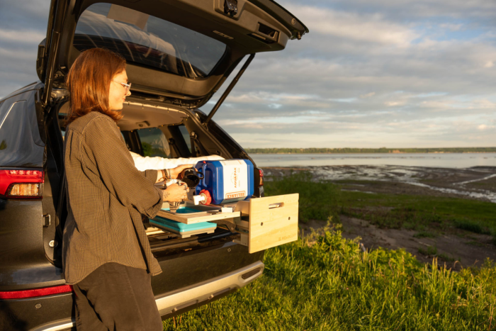Portable Reliant water jug in the Roadloft camper setup, designed for easy water access during camping trips.