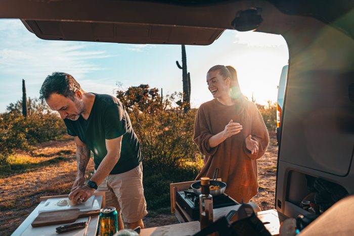 Camp kitchen setup inside an SUV using the Roadloft camper kit, designed for efficient outdoor cooking.