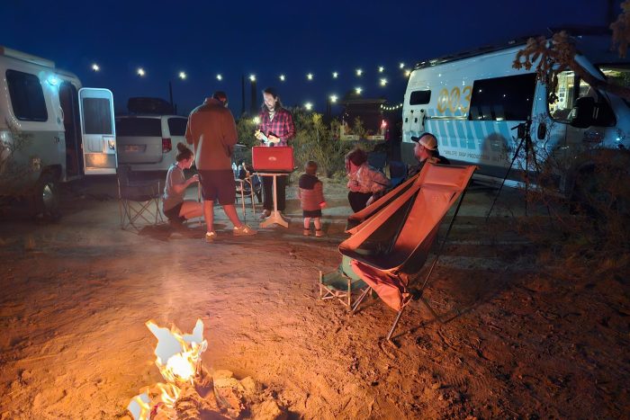 Group of vanlifers enjoying cooking and dining together outdoors with Roadloft camper kits